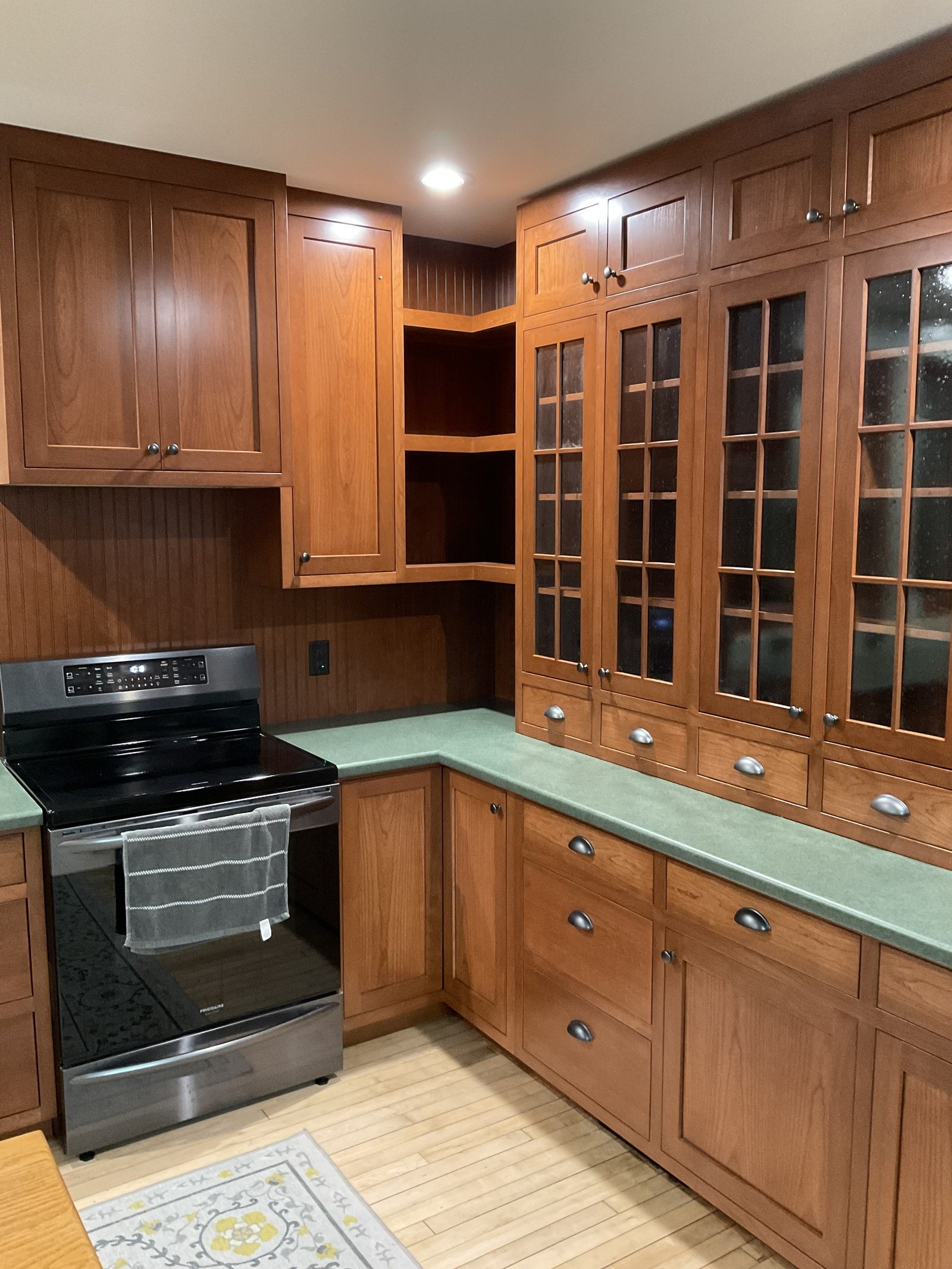 Cherry kitchen with glass-front cabinets
