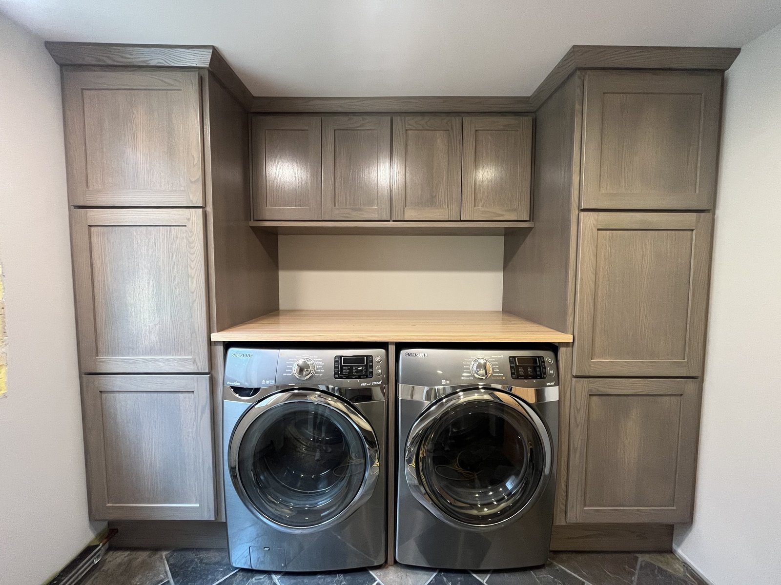 Custom laundry cabinetry with washer and dryer