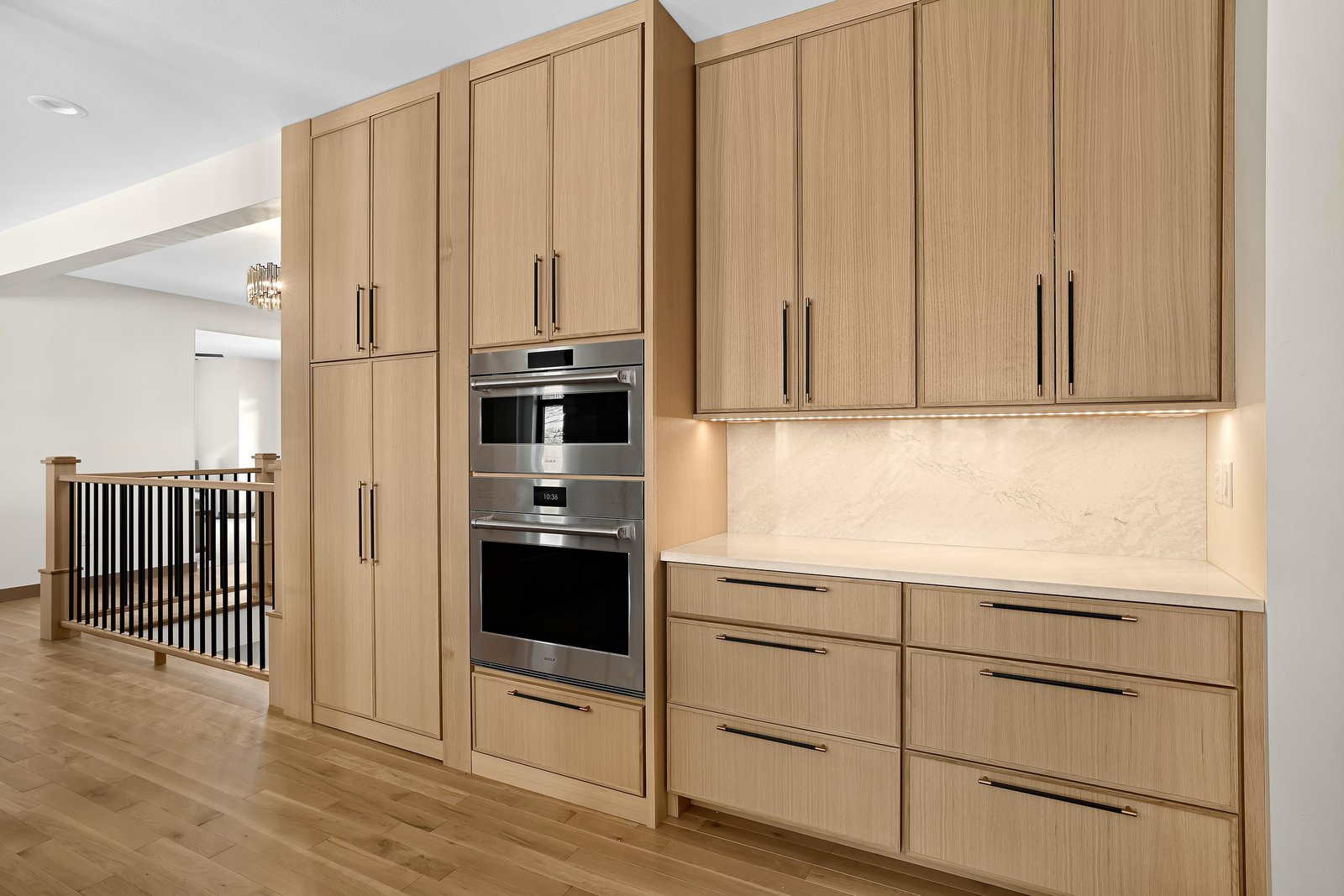 Natural oak floor-to-ceiling kitchen cabinets