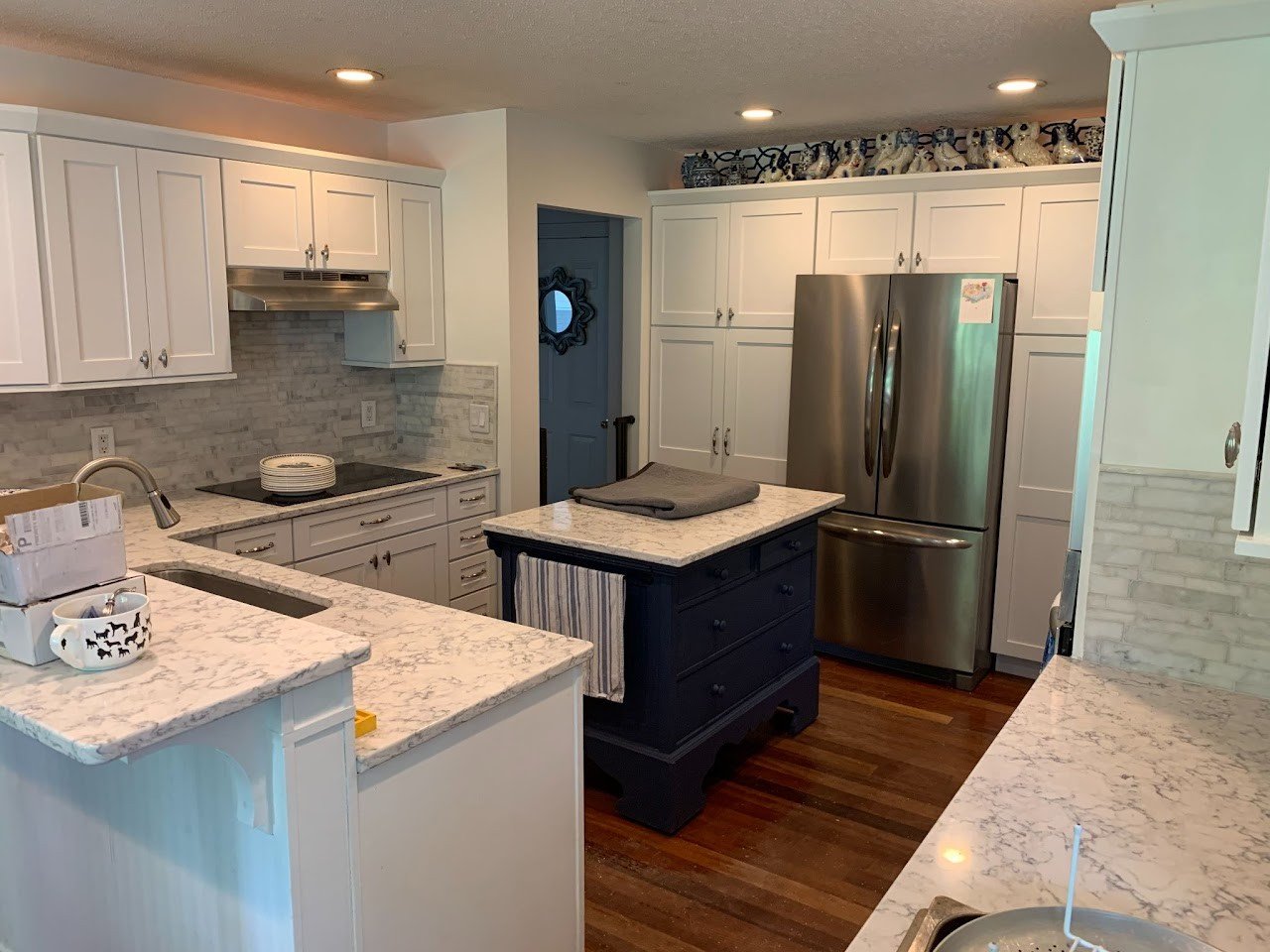 White kitchen with contrasting dark island