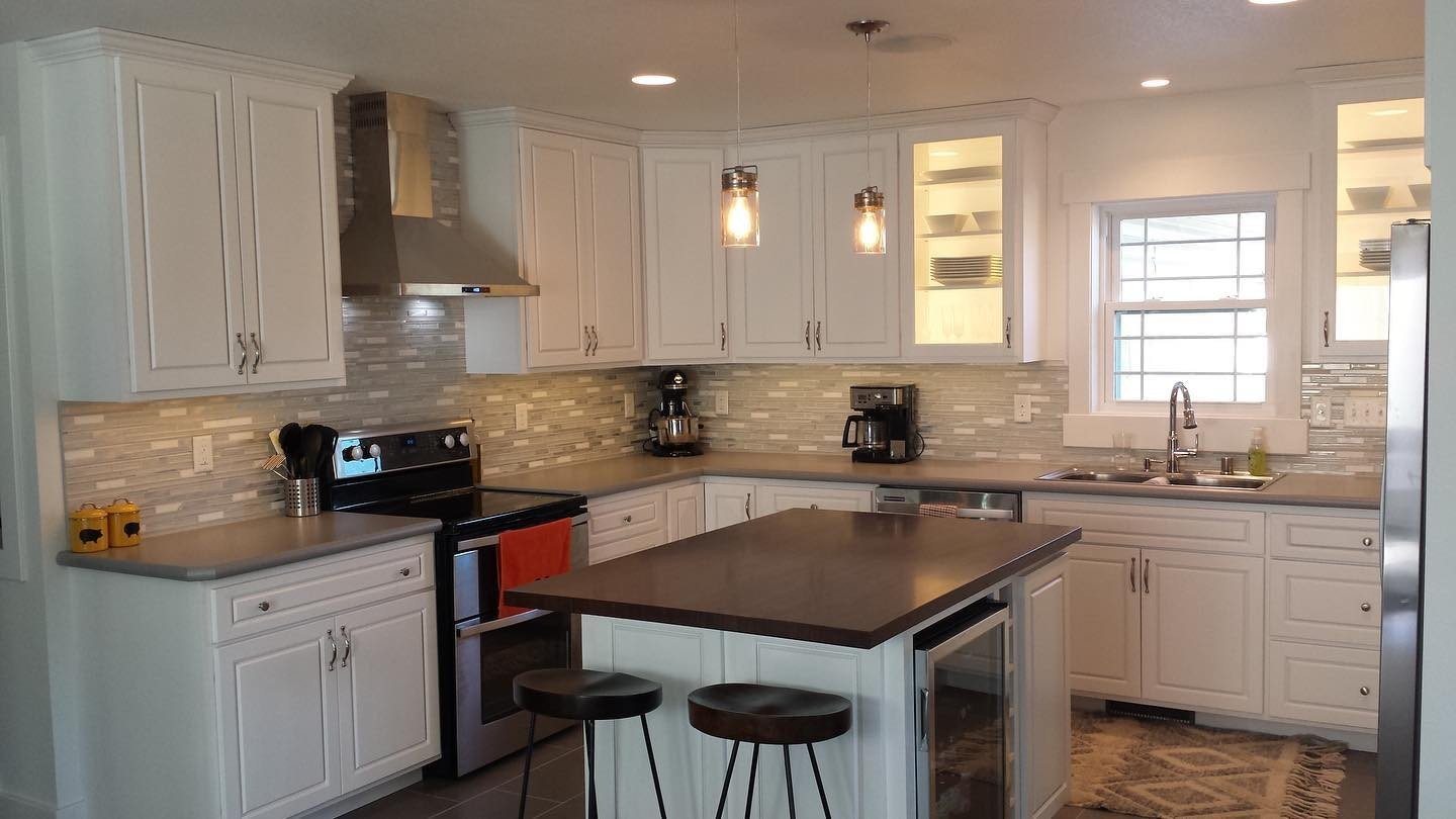White kitchen with dark island and wood countertops