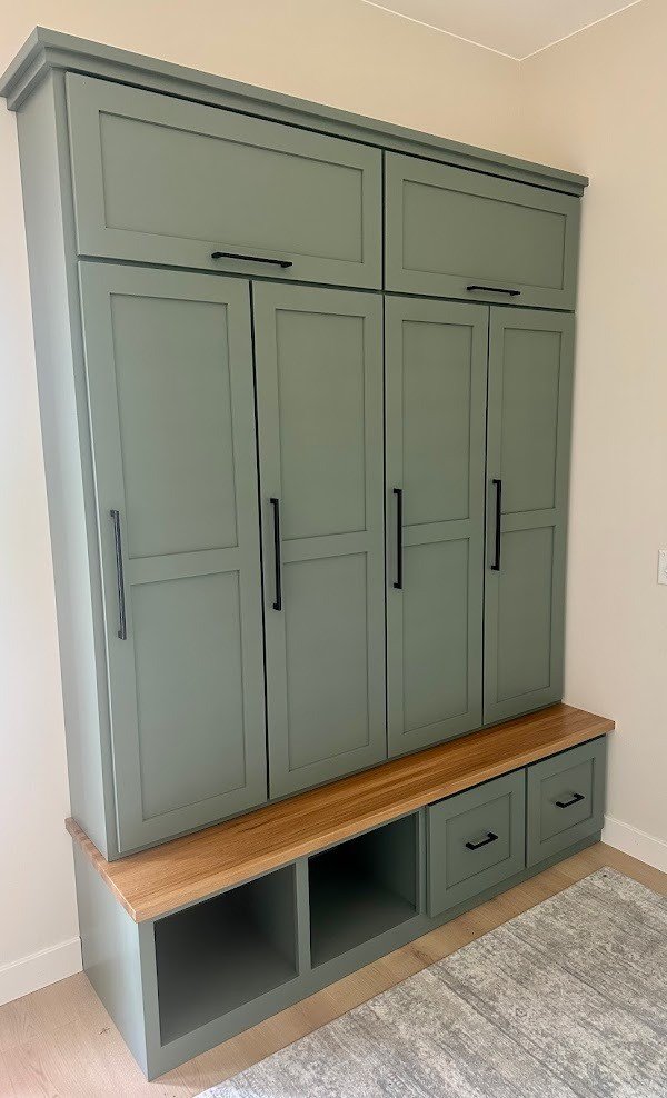 Sage green painted storage cabinetry