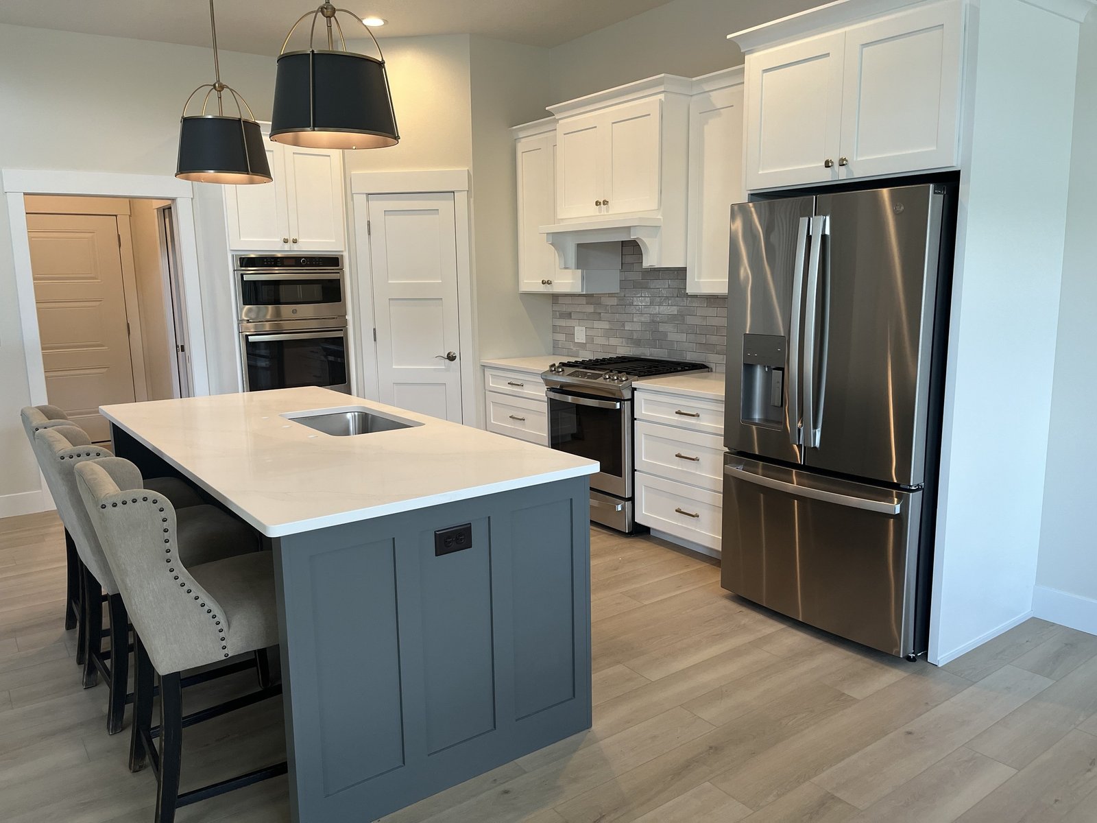 White painted kitchen with contrasting gray island